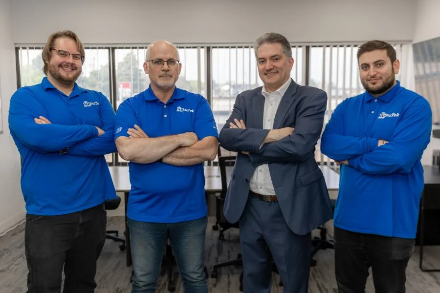 Four ITBizTek team members standing together at the North York office.